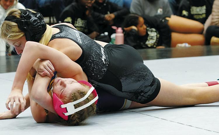 Maci Puppe in the 100 lb weight class pins her opponent. Photo by Larry Stokke.