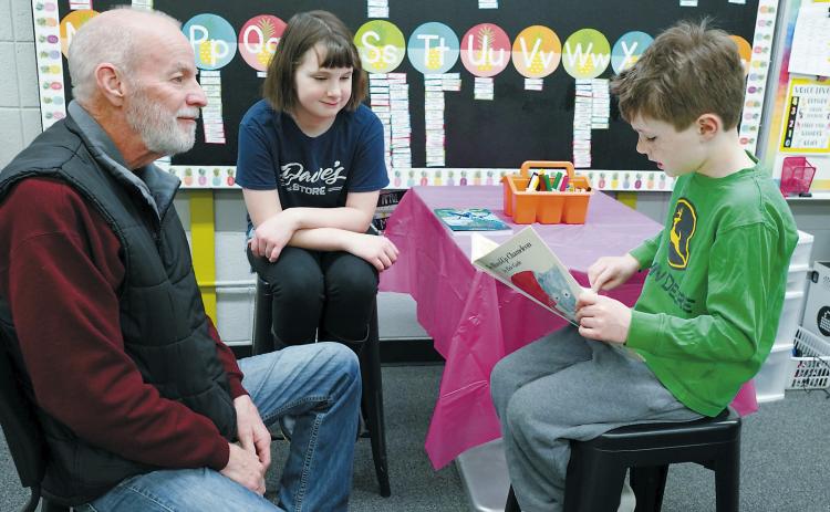 The Borderland Press's very own photographer had a chance to participate in National Reading Month with Callen and Elin Hinnenkamp reading to him at St. Alphonsus School last week.