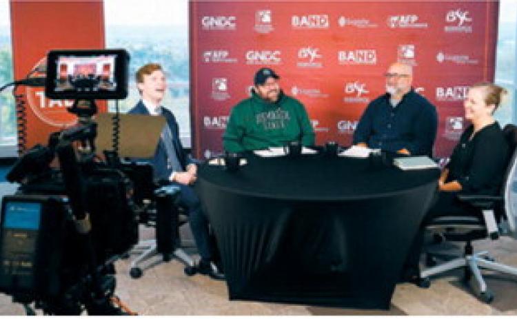 North Dakota Superintendent Levi Bachmeier, left, and superintendent candidate Tracy Foss, right, check the camera locations next to Plain Talk Podcast hosts Rob Port, center-left and Chad Oban, center-right, at Bismarck State College on Oct. 13, 2026, before beginning their debate for superintendent for the Department of Public Instruction. (Photo by Michael Achterling/North Dakota Monitor)