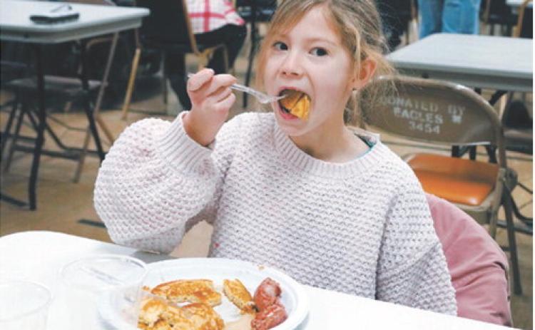Layken Hansel is all in on breakfast on New Year’s Day at the Masonic Center in Langdon, where Lebanon Lodge #34 held its 8th annual pancake feed. The free will offering collected will benefit the Glen Symons Memorial Masonic Scholarship Fund. Photo by Larry Stokke.