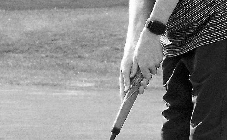 Dyson Askvig sinks a putt at Grafton on May 14. Photo by Larry Stokke.