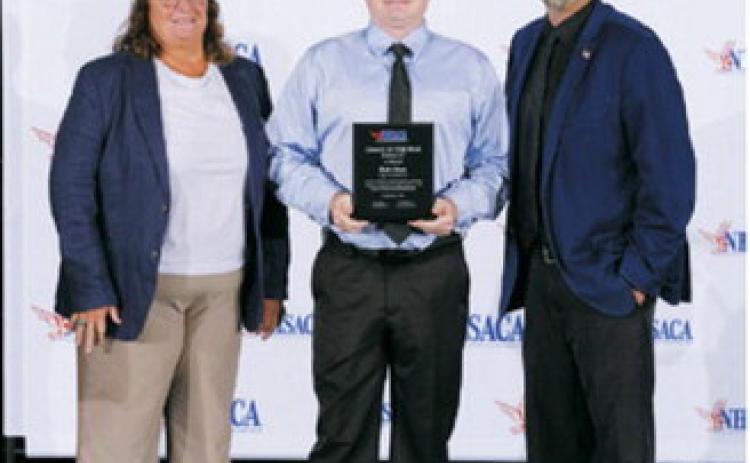 Rich Olson, center, was recognized as a National High School Athletic Coaches Association (NHSACA) Volleyball Coach of the Year finalist during the organization’s national awards presentation. Olson is pictured with NHSACA Volleyball Sports Chair Jean LaClair, left, and NHSACA President Scott Jarvis. Photo submitted
