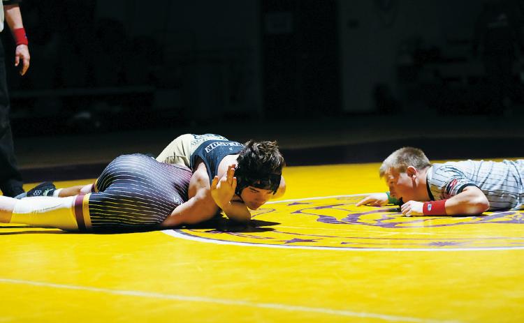 Abel Emerson pinned his Watford City opponent to win his 145 pound weight class in Belcourt on Dec. 4. Photo by Larry Stokke.