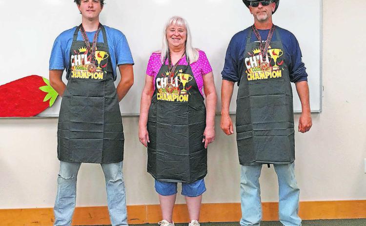 From (L-R) winners: Jonathan Lill for “tastiest,” Debbi Flowers for “spiciest,” and Robert Mackall for “fan favorite.” PHOTO BY LARRY STOKKE