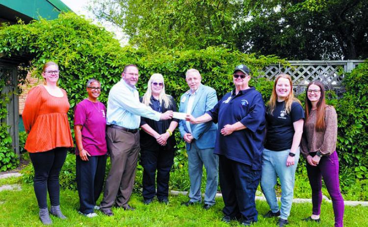 (L-R) Anna Lill, Shanda Christianson, Pastor Burton Van Kirk, Lorraine Gage, Wayne Reid (LPH CEO), Chris Sanders (Ambulance Director), Hope Thorlakson, and Jessica Tank. Photo by Larry Stokke.
