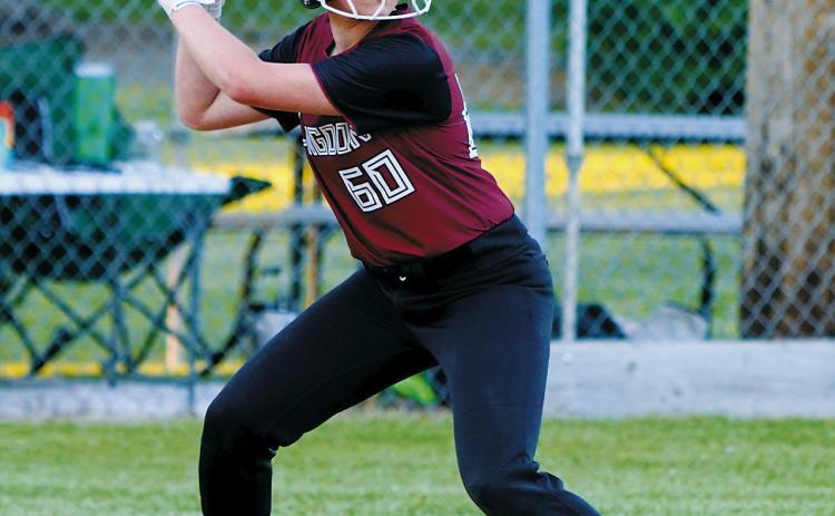Harper Jacobson keeps her eye on the ball before driving it into the outfield for a base hit during Langdon Area/Munich's victory over Larimore on June 25 in Munich. Photo by Larry Stokke