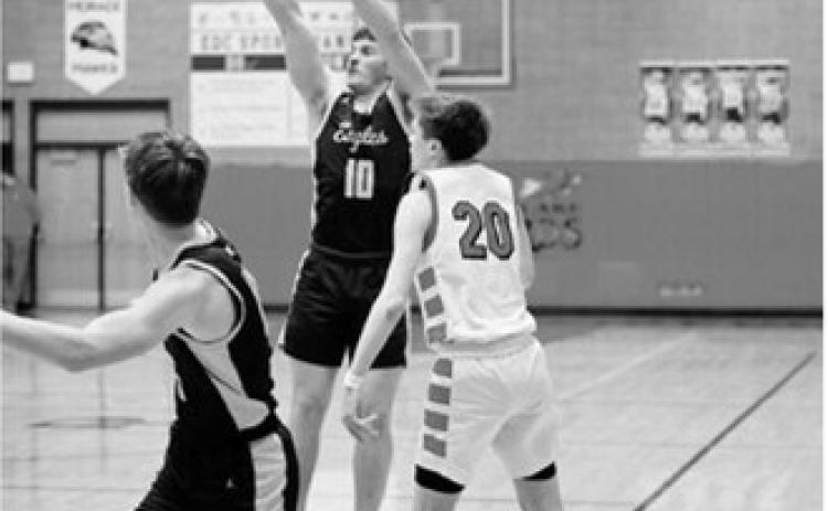 Colton Bailly shoots beyond the arch for three points. Photo by Ashley Schafer