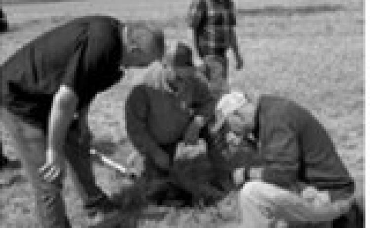 Jimmy Emmons, Darrel Oswald and Dave Bauer evaluate soil structure, residue distribution and infiltration indicators in a wheat field near Regan, N.D., while Jarvis Keney observes. The Aug. 25 tour was held to highlight regenerative agriculture and conservation planning ahead of the Advancing Soil Health Summit.