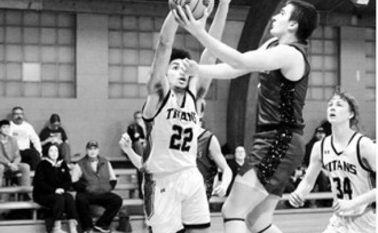 Eastyn Schaefer drives to the basket and finger rolls in a layup when the Cards played the Titans. Photo by Larry Stokke