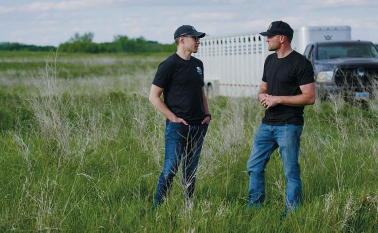 Cory Hepola [right] speaks with Kevin Leier of Heartland Bison Ranch. Photo by The Brookshire Company.
