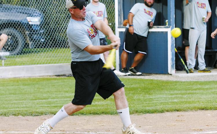 Aaron Johnson drives one into the outfield for a base hit in the Legacy Alumni Tournament where Langdon, Munich, and Edmore competed against one another. Photo by Larry Stokke.