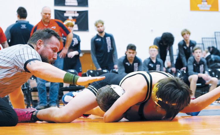Abel Enerson gets the pin as former Langdon wrestler Marty Mikkelsen signals the pin. Photo by Larry Stokke.