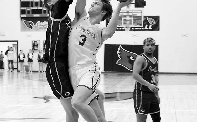 Cody Amble puts up a shot under pressure from a Spoiler defender in Langdon on Jan. 6. Photo by Larry Stokke.