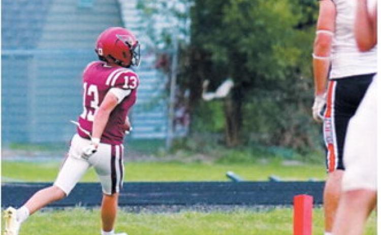 Langdon Area-Munich’s Gavin Trottier, an FM Bank co-player of the game, crosses the goal line on a 27-yard touchdown run during the Cardinals’ win over Rugby on Sept. 18. Photo by Larry Stokke