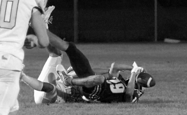 Weston Cosley tackles Jory Samuelson, causing a fumble. Photo by Larry Stokke.