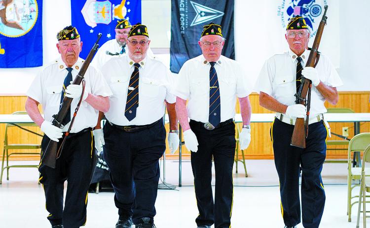 The Post 98 Color Guard opened the program (L-R) Harvey Metzger, Dennis Hansel, Larry Murie, and Leon Hiltner. Photo by Larry Stokke.