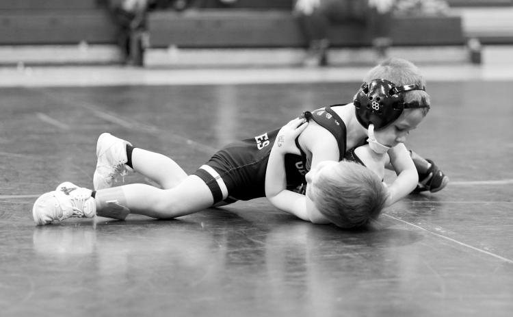 Gunnar McKay attempts to pin his opponent. Photo by Larry Stokke.
