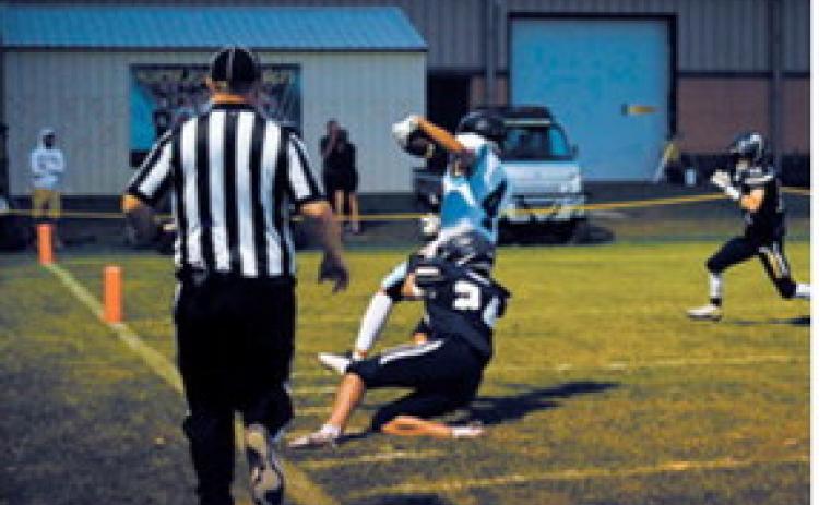 North Border’s Jaxon Suedel catches up with the ball carrier downfield and brings the run to a stop. Photo by Ashley Schafer