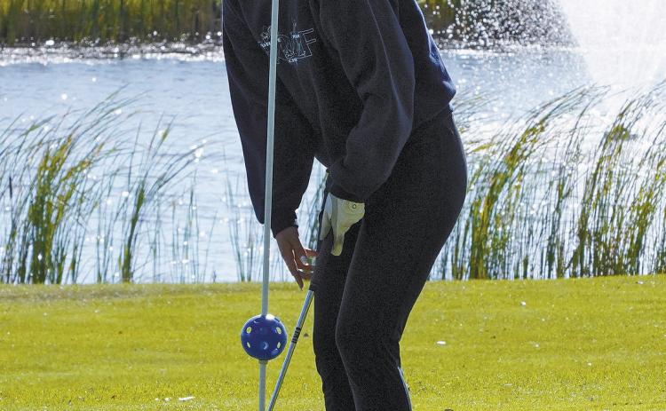 Rylee Medbery drops the ball in the cup at the Lakota Meet. Photo by Larry Stokke.