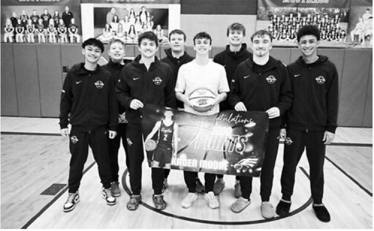 Kaden Moore scored his 1,000th career point for the North Border Eagles, in a game Minto on January 20th... Pictured is Kaden with his teammates, and with a basketball commemorating the moment. Congrats Kaden Moore!