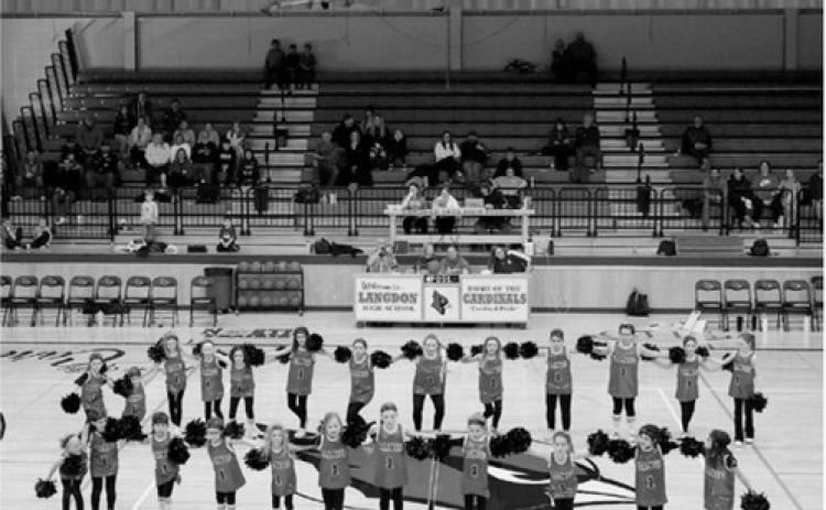 The Cardinal Pom Squad kept the crowd entertained at half time of a recent game. This squad is for grades one to five. Photo by Larry Stokke