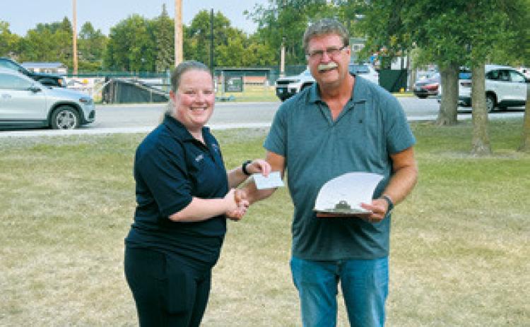 Cavalier County Farm Bureau President Paul Henderson, right, presents a $2,500 donation to Adam Westphal of the Munich Ambulance Service. Photo by Megan Overby, NDFB Northeast Field representative