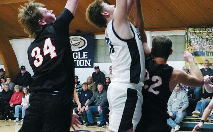 Preston Emerson gets fouled while going in for a layup, then drops in two free throws. Photo by Larry Stokke.