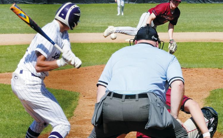 Devin Hakanson delivers a strike to a Bottineau payer in the Cards' win in Bottineau on May 10. Photo by Larry Stokke.