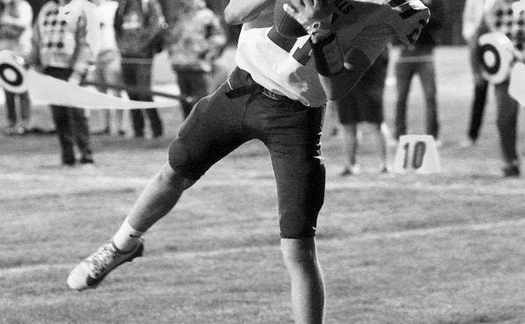 Eastyn Schaefer scores a 2 point conversion to put the Cards ahead of the Hornets for the win. Photo by Larry Stokke.