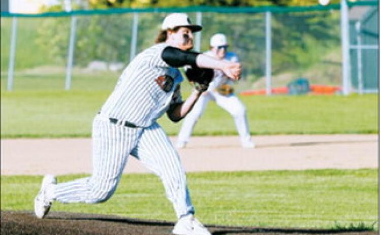 Theo Romfo delivers a strike during Langdon Area/Munich’s victory over Grafton on June 11. Photo by Larry Stokke