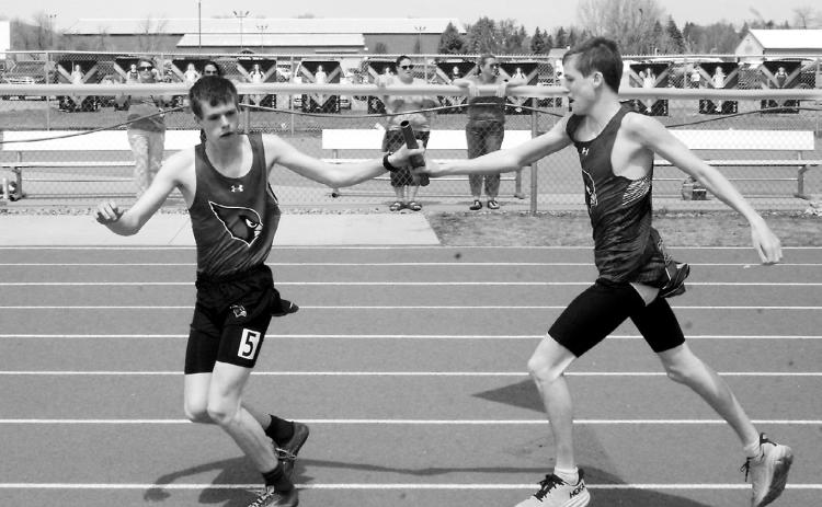 Kaleb Foster hands the baton off to Noah Foster who, with Jayden Lee and Tyler Borgen, finished 2nd in the 4x800 meter relay. Photo by Larry Stokke.