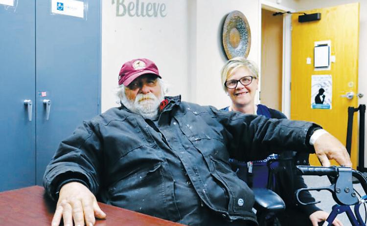 Michael Hauck, 64, left, a homeless veteran, sits next to Kris Morrissette, behavioral health manager at Ministry on the Margins in Bismarck, before being transported to a nearby hotel as he awaits approval to move into a nearby apartment on Nov. 6, 2025. (Photo by Michael Achterling/ North Dakota Monitor)