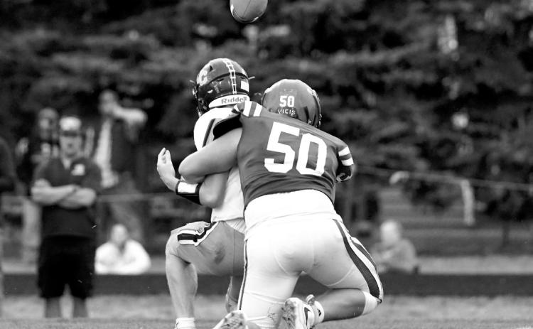 FM Bank Player of the Game Landon Schneider records a quarterback sack during the Cardinals’ win over Valley City. Schneider also made several tackles for loss. Photo by Larry Stokke