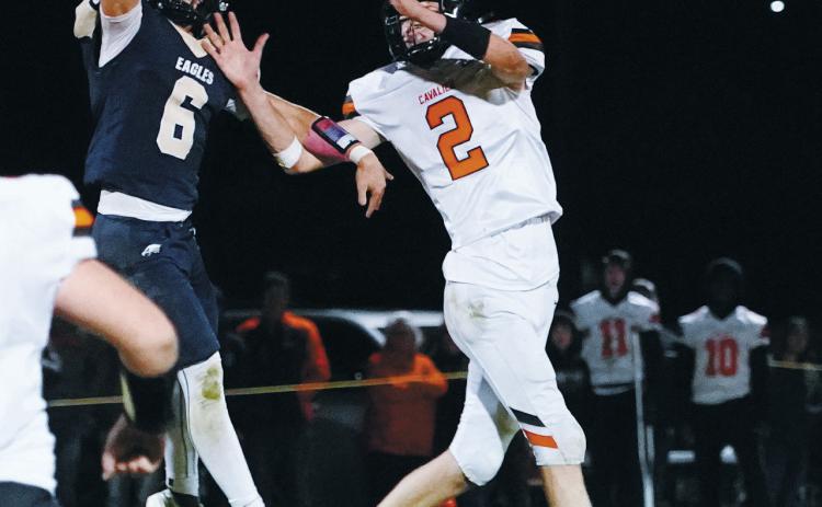 Grant Cosley breaks up an attempted pass to Ryan Pelletier. Photo By Larry Stokke.