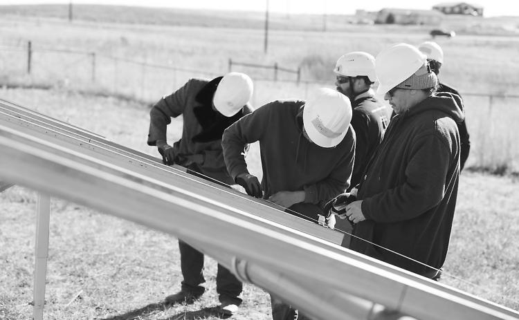 Indigenized Energy technicians work to erect a ground-mounted residential solar project at Pine Ridge Reservation in October 2024. Around 30 trainees from the tribe participated, with six of those later hired by a contractor taking part in the project. Photo provided. Photo provided