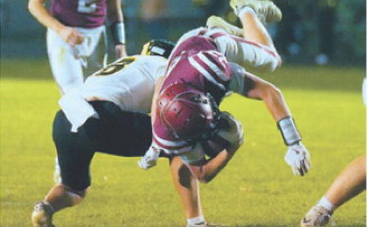 FM Bank Co-Player of the Game Austin Wenzel dives past an Aggies defender for a first down. Photo by Larry Stokke