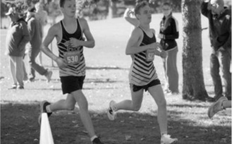 Nolan Pelletier and Micah Crosby run the course at the Rugby Booster Club Invitational on Oct. 3. Crosby finished 37th out of 208 runners. Photo by Larry Stokke