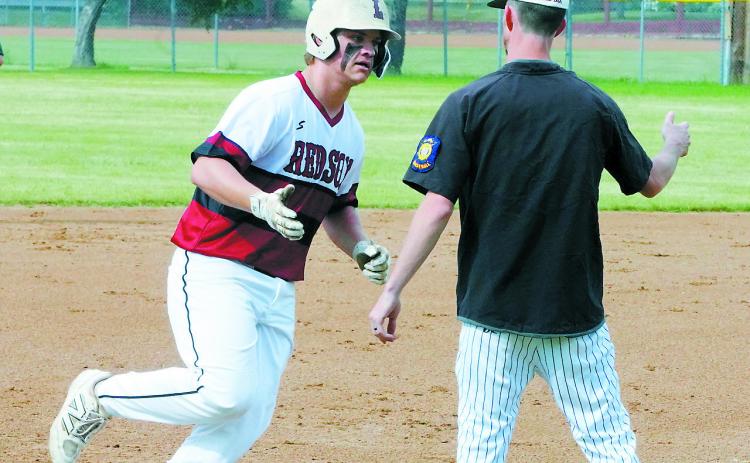 Coach Groth congratulates Theo Romfo on his home run hit against Thompson June 18 in Langdon. Photo by Larry Stokke.