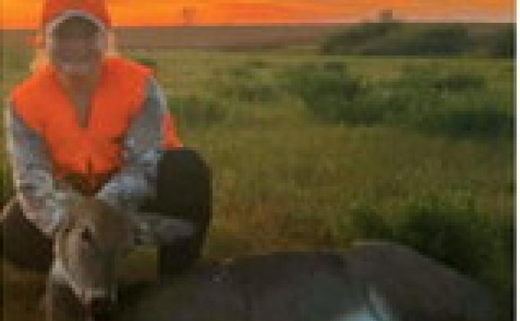 Bailey Samuelson poses with a deer harvested during the youth rifle season, with a beautiful sunset in the background. Photo submitted by Greta Samuelson
