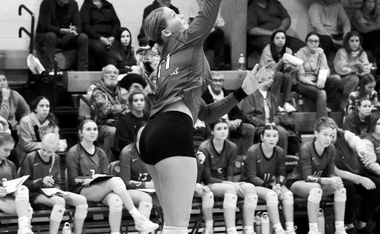 Emma Hall serves up an ace in the Cards three-set win over the Bearcats. Photo by Larry Stokke.