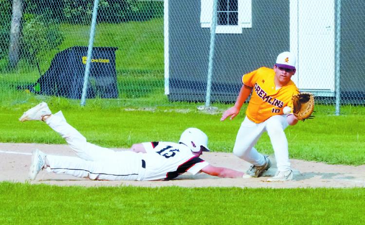 Luke Gilseth gets back to first base quickly beating the tag-out in the win over Grafton June 3 in Langdon. Photo by Larry Stokke
