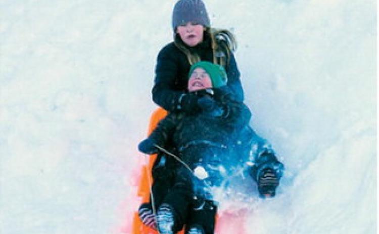 Two youngsters are captured by the camera lens sliding down a giant hill in Langdon ahead of our back-to-back blizzards last week. Larry Stokke / for the Borderland Press