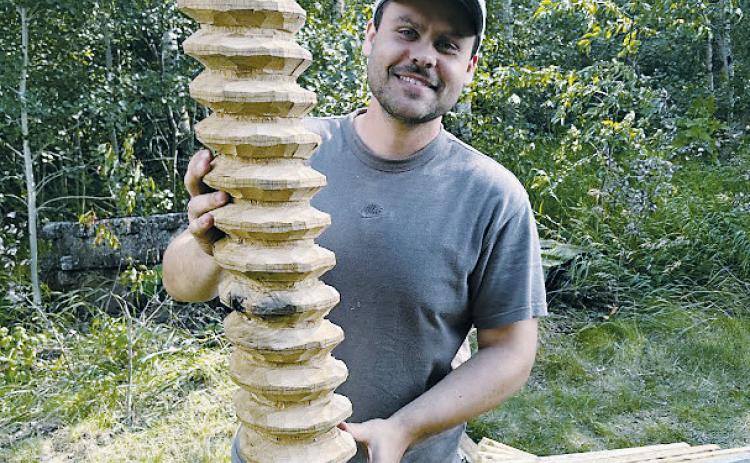 Master woodworker Talon Stammen displays the handcrafted wooden screw he created for the Pembina County Historical Museum’s new apple cider press. The press was built using traditional hand tools and locally harvested timber. Photo courtesy of Pembina County Historical Museum