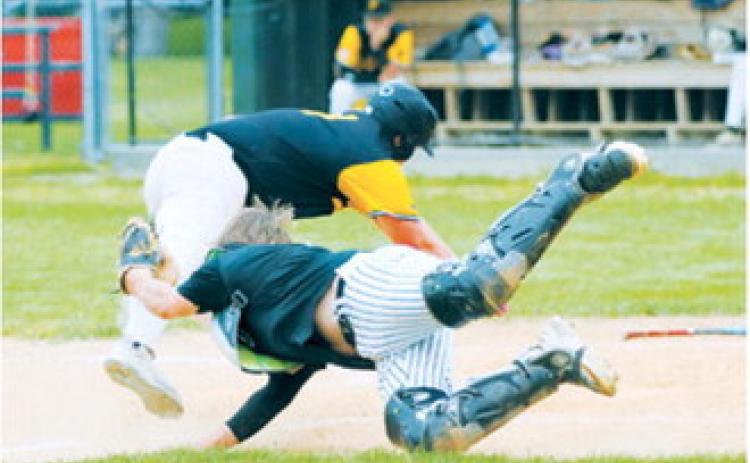 Devin Hakanson dives to apply the tag at home plate as a Park River runner attempts to score during Langdon's victory. Photo by Larry Stokke