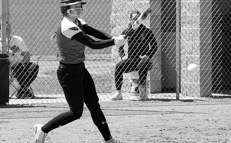 Meredith Romfo connects for a base hit against Thompson. Photo by Larry Stokke.