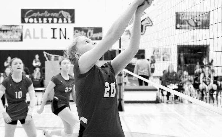 Sophi Witzel passes the ball over her shoulder to a teammate April 24 in the Cards’ win over Lakota. Photo by Larry Stokke.