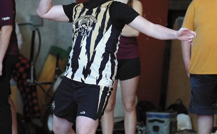 Michael O’Connor winds up and throws the shot put at the indoor meet in Grand Forks. Photo by Larry Stokke