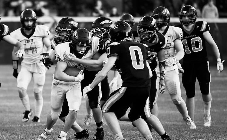 Brody Berg fights for extra yardage as multiple defenders converge to bring him down. Photo by Ashley Schafer.