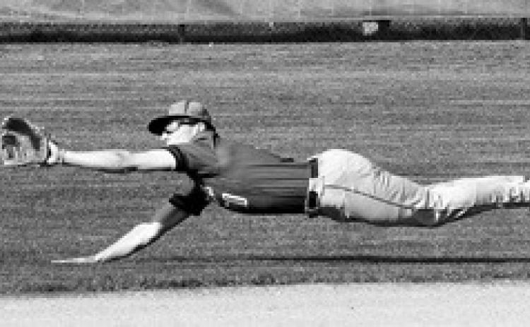 Mason Romfo stretches out, diving to catch the ball against the Spoilers in Langdon on May 13. Photo by Larry Stokke.