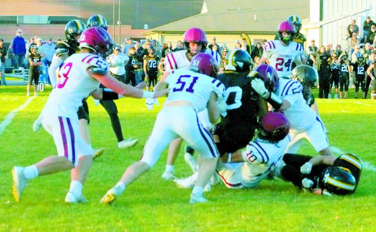 An Aggie ball carrier is stopped from making a first down by a flock of Cardinals in Park River. Photo by Larry Stokke.